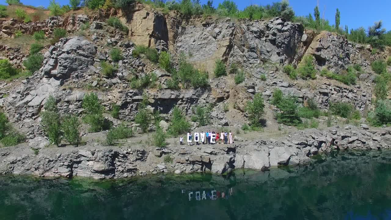 Inscription Love On The Coast. Aerial shot of a Love word near waterline