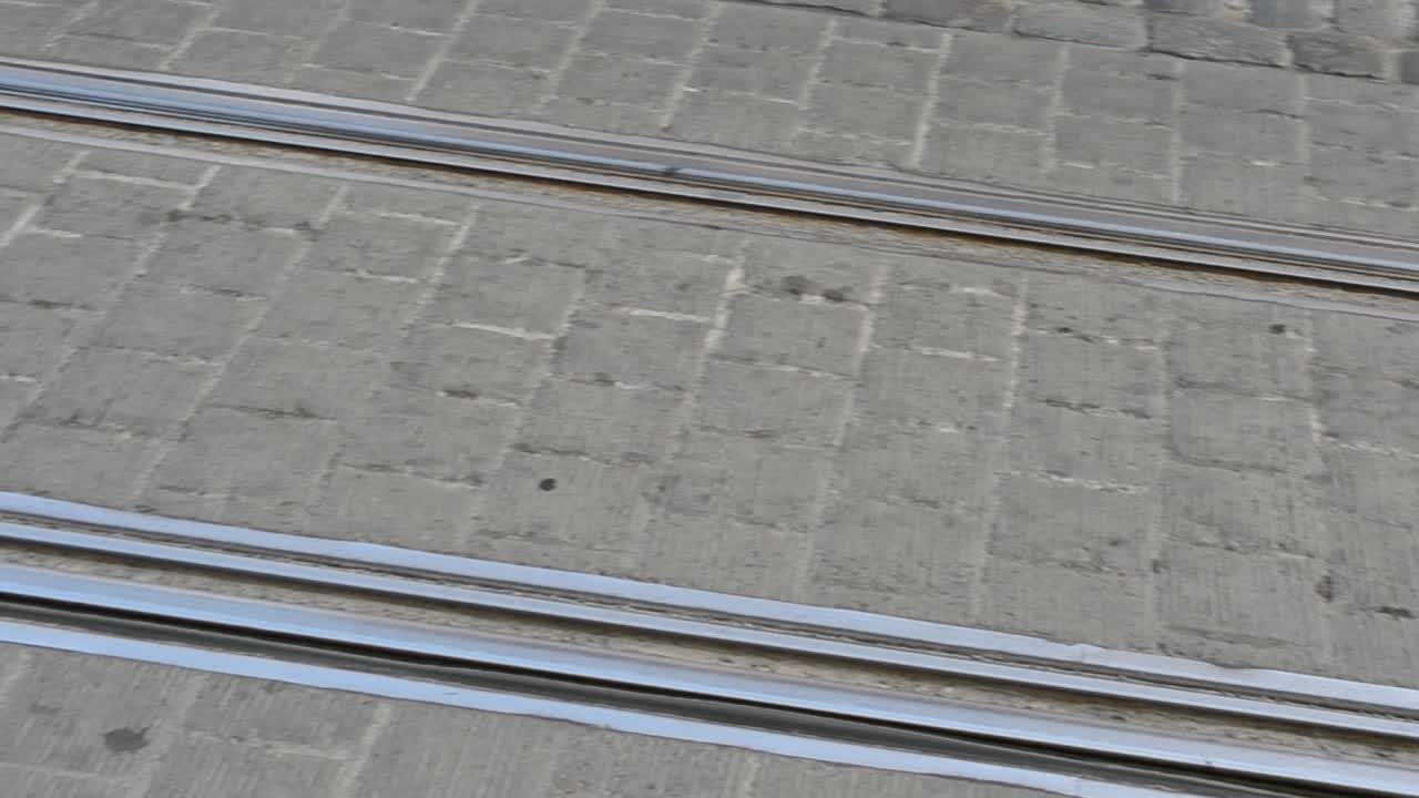 Pavement in the city. Rails and tram