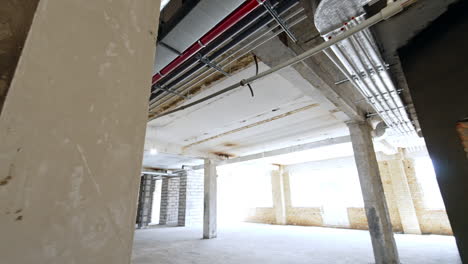 pipes and isolated wires on the ceiling of the building. tour by the interior of the construction site.