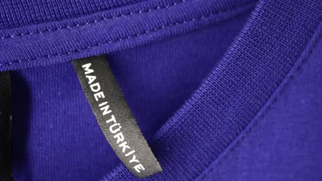 close-up of a made in turkey tag on a purple t-shirt