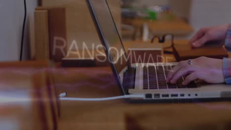 Animation-of-ransomware-text,-electric-current-over-cropped-hands-of-caucasian-man-working-on-laptop