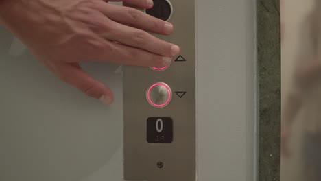 Close up hand pressing Elevator button. Elevator call button.