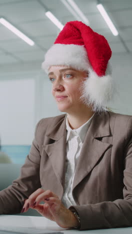 woman in santa hat in office