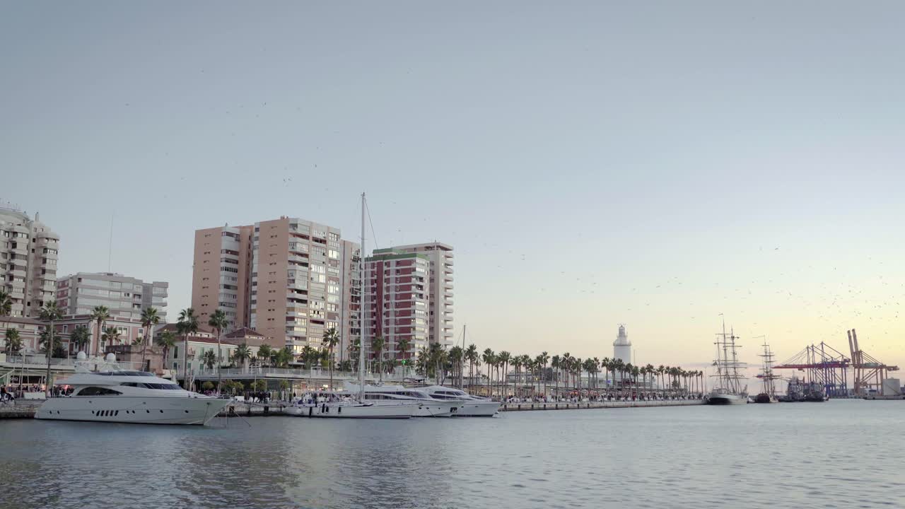 Yachts parked in port Malaga, Spain, view on promenade Paseo del Muelle Uno