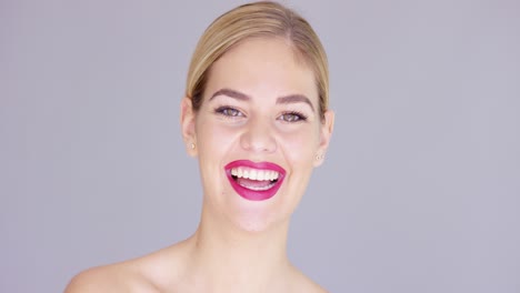 laughing young woman wearing red lipstick