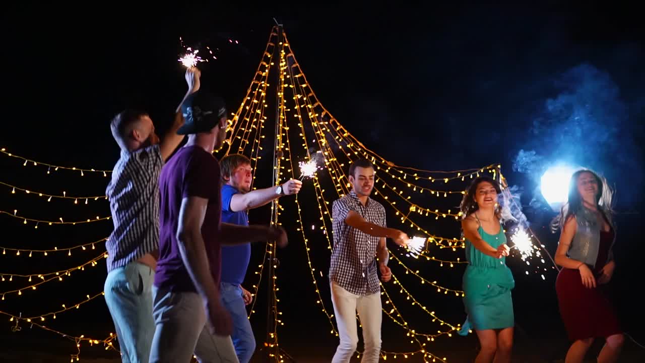 Friends Celebrating at Night with Sparkler