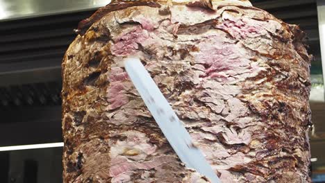 close up of a doner kebab rotating on a spit