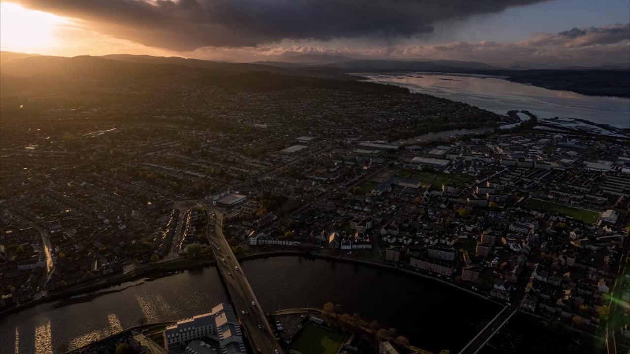 drone timelapse disparó por encima de inverness con la puesta de sol en el horizonte, hiperlapso aéreo