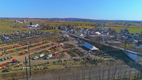 an aerial view of an amish mud sale in pennsylvania selling amish products on a sunny day