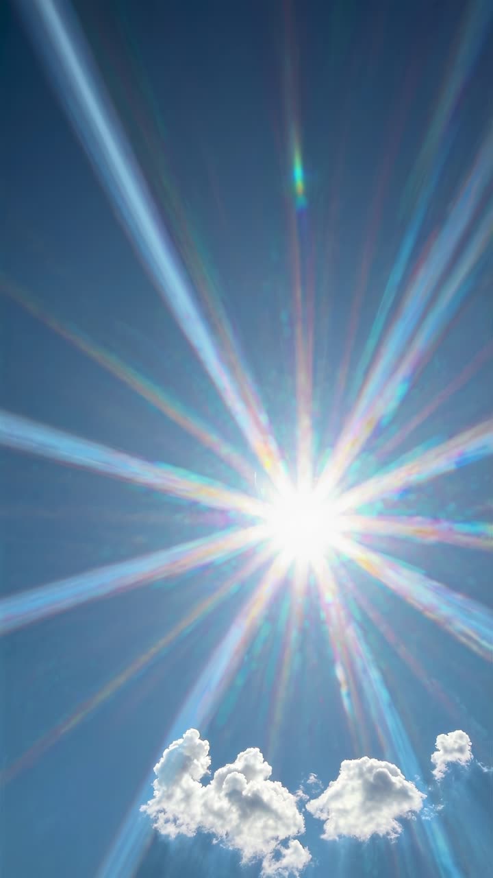 A dynamic video captures the sunburst effect with radiant beams and fluffy clouds, shot from a low