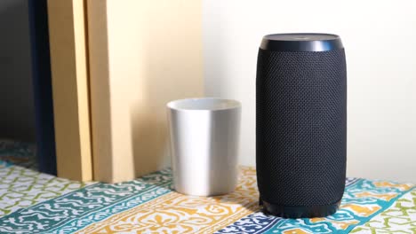 black cylinder portable bluetooth speaker on table