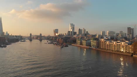 stable drone shot over london thames river towards city centre sunset
