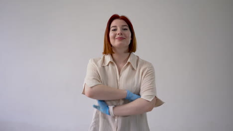 confident woman takes off medical face mask and throws it. end of the covid-19 pandemic. copy space and white background.