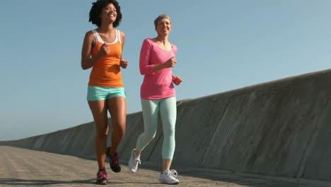 two fit women running together