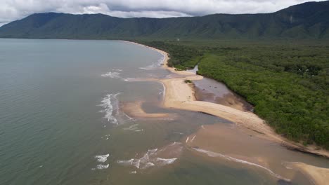 Aerial-View-of-Empty-Sandy-Beach-and-Thick-Coastal-Forest-Along-Coast-of-Queensland,-Australia