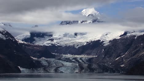 johns hopkins glacier and the snow capped mountains around it and clouds