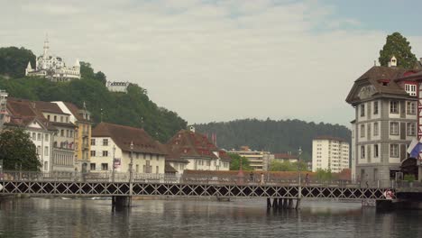 reussbrücke crosses river reuss in medieval old town of lucerne, switzerland