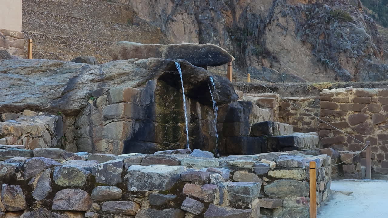 A detailed view of an ancient ceremonial fountain in the Ollantaytambo archaeological park, Peru, showcasing the intricate stonework and historical significance of this Inca site