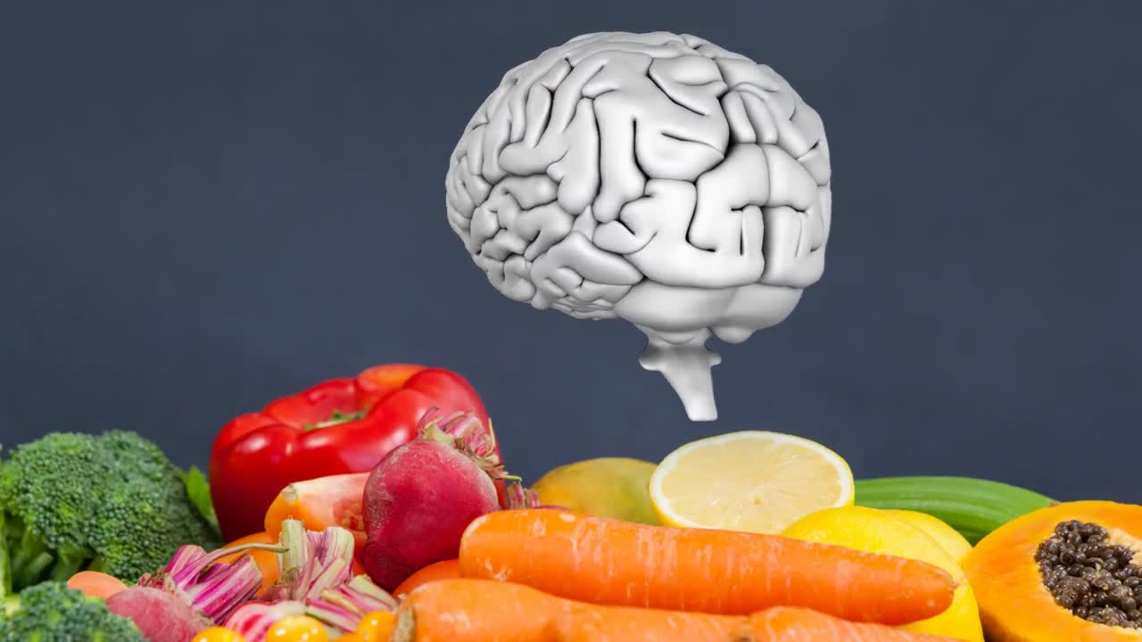 animación del cerebro rotando sobre un fondo gris con verduras y frutas