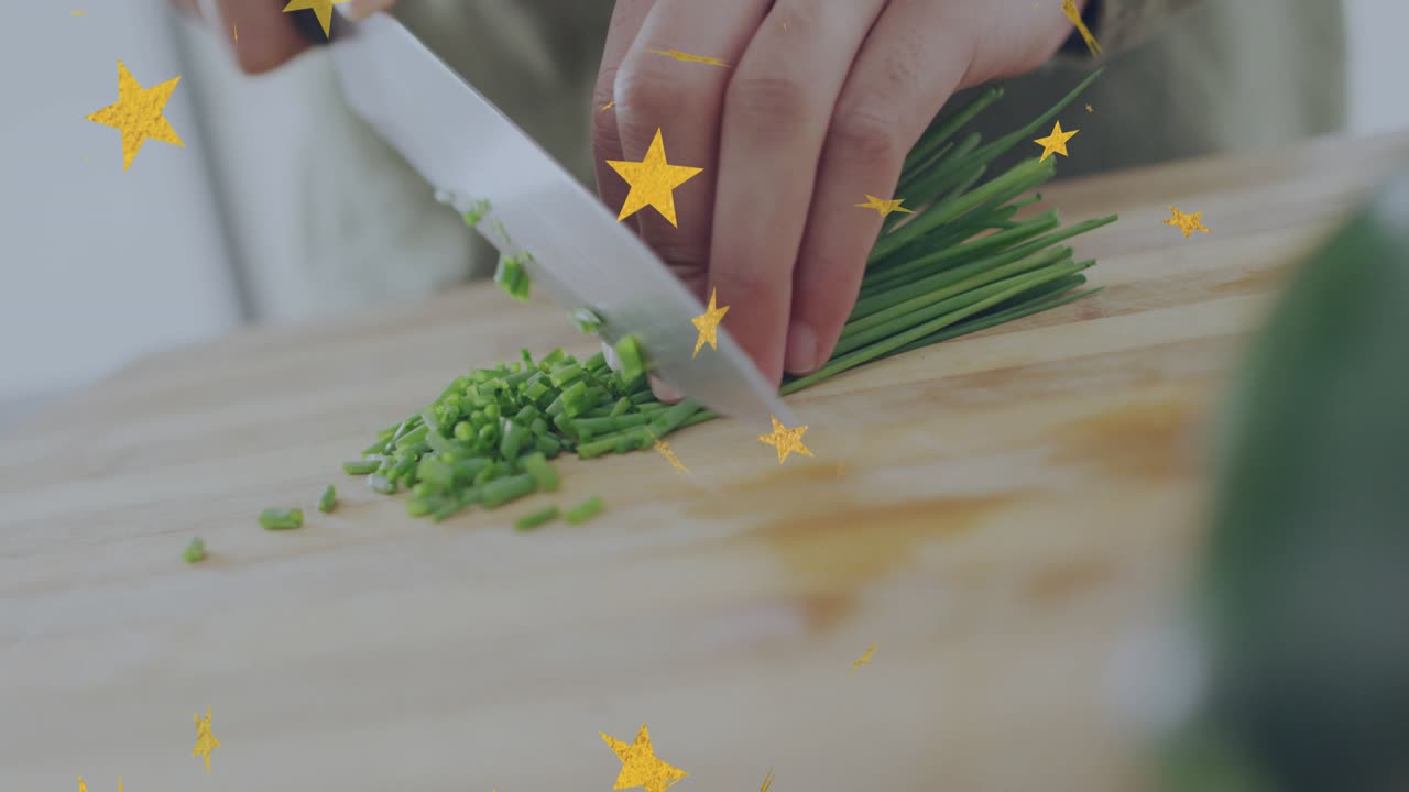 Woman's hands starting knife contact, chopping chives on board for culinary garnish, stars drifting