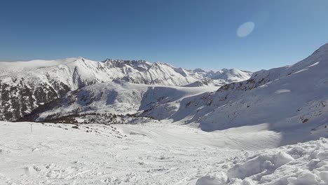 Horizon-of-mountains-covered-with-snow-with-ski-tracks-on-in-Bansko,-Bulgaria