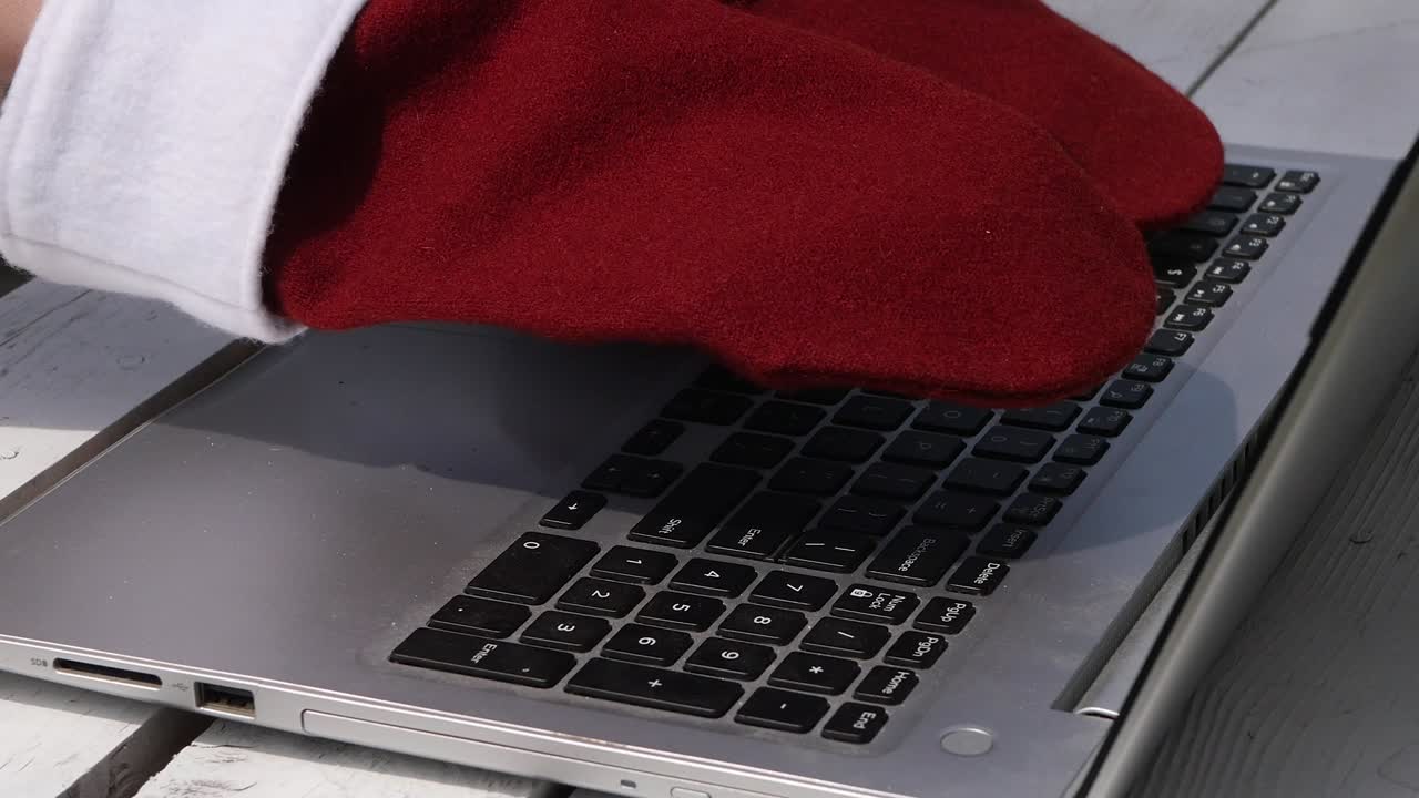 Close up Santa typing on laptop