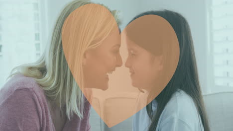 animation of heart over caucasian mother and daughter