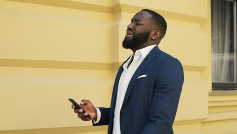 upset afro businessman receiving bad message