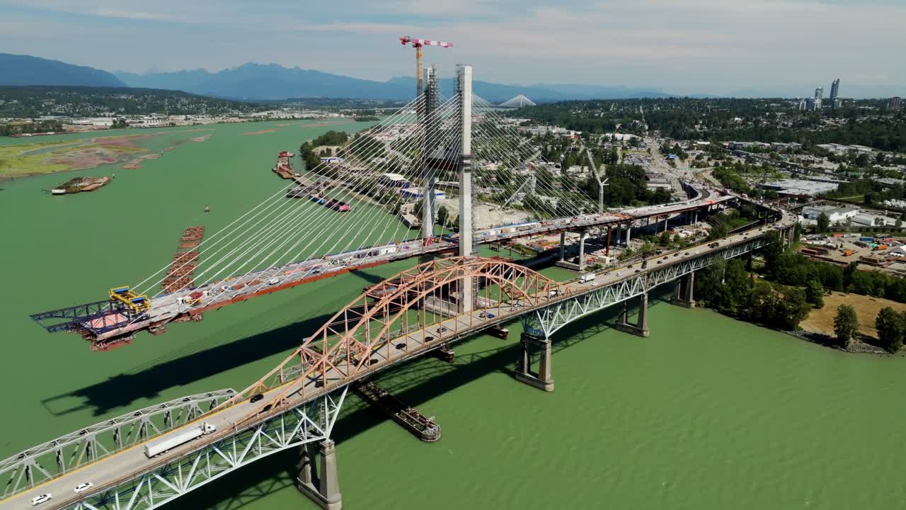 New Westminster, Canada – Pattullo Bridge Replacement Under Construction Beside Existing Bridge to Improve Transportation Infrastructure and Safety – Aerial Drone Shot