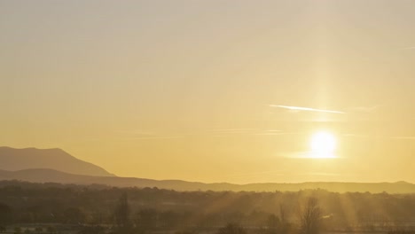 sun rising over horizon in mountains