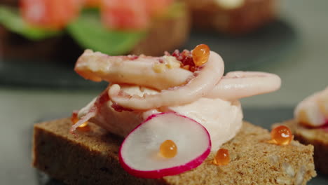 appetizer platter with smoked squid, caviar, and radishes