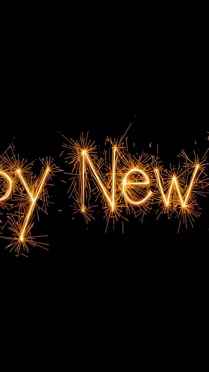 Vertical video: Flickering at start, styled Happy New text sending gold sparks on black as greeting