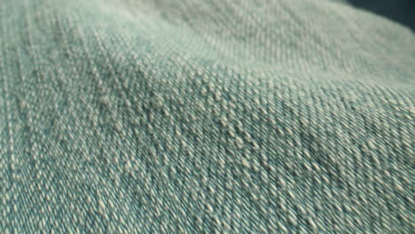 extreme close-up along blue, denim fabric