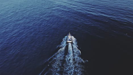 Drone-shot-of-fishing-boat-tilting-up-and-moving-backwards