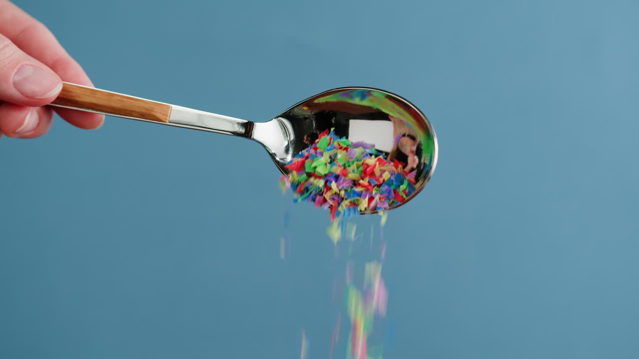 Colorful Confetti Falling from a Spoon