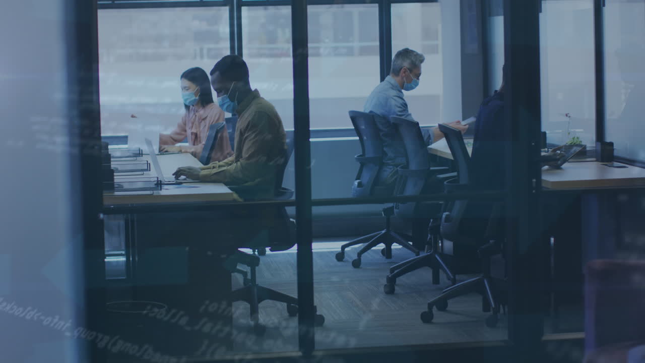Animation of data processing over diverse business people with face masks using laptops