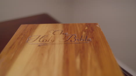 wrap around wooden book box labeled holy bible on side table