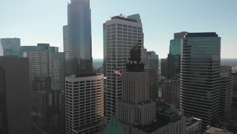 aerial footage of america's flag, downtown minneapolis behind