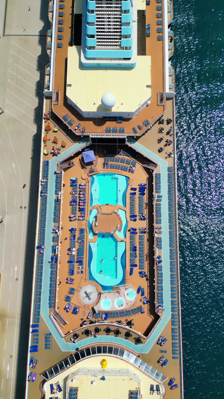 Aerial drone view of the top of a yacht docked. Vertical