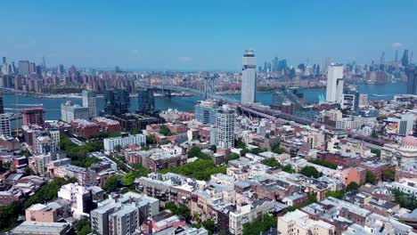 drone aerial landscape of manhattan bridge brooklyn city cbd skyline towers buildings housing commercial apartments williamsburg new york usa america urban travel tourism