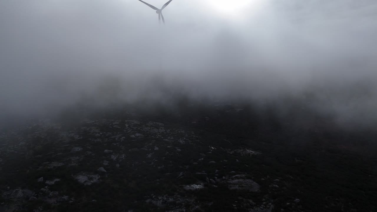Wind turbine reveal from inside the clouds