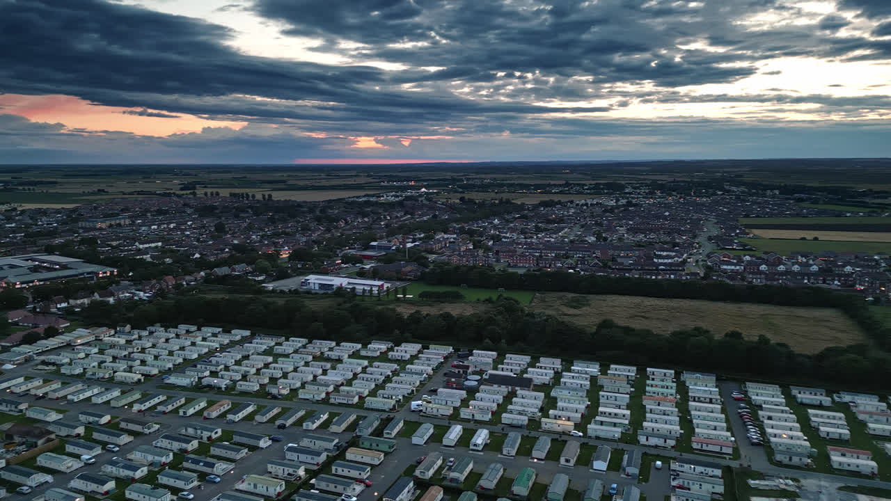Skegness at sunset from a drone's perspective: holiday park, beach, caravans, sea, and scenic vistas