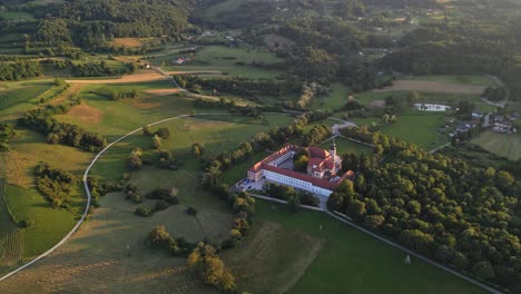 Atemberaubende-4K-Drohnenaufnahmen-Des-Zisterzienserklosters-Kostanjevica-Na-Krki-Und-Goldenes-Sonnenuntergangslicht