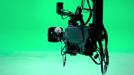 the camera jib is moving in a professional green screen studio. film and television industry