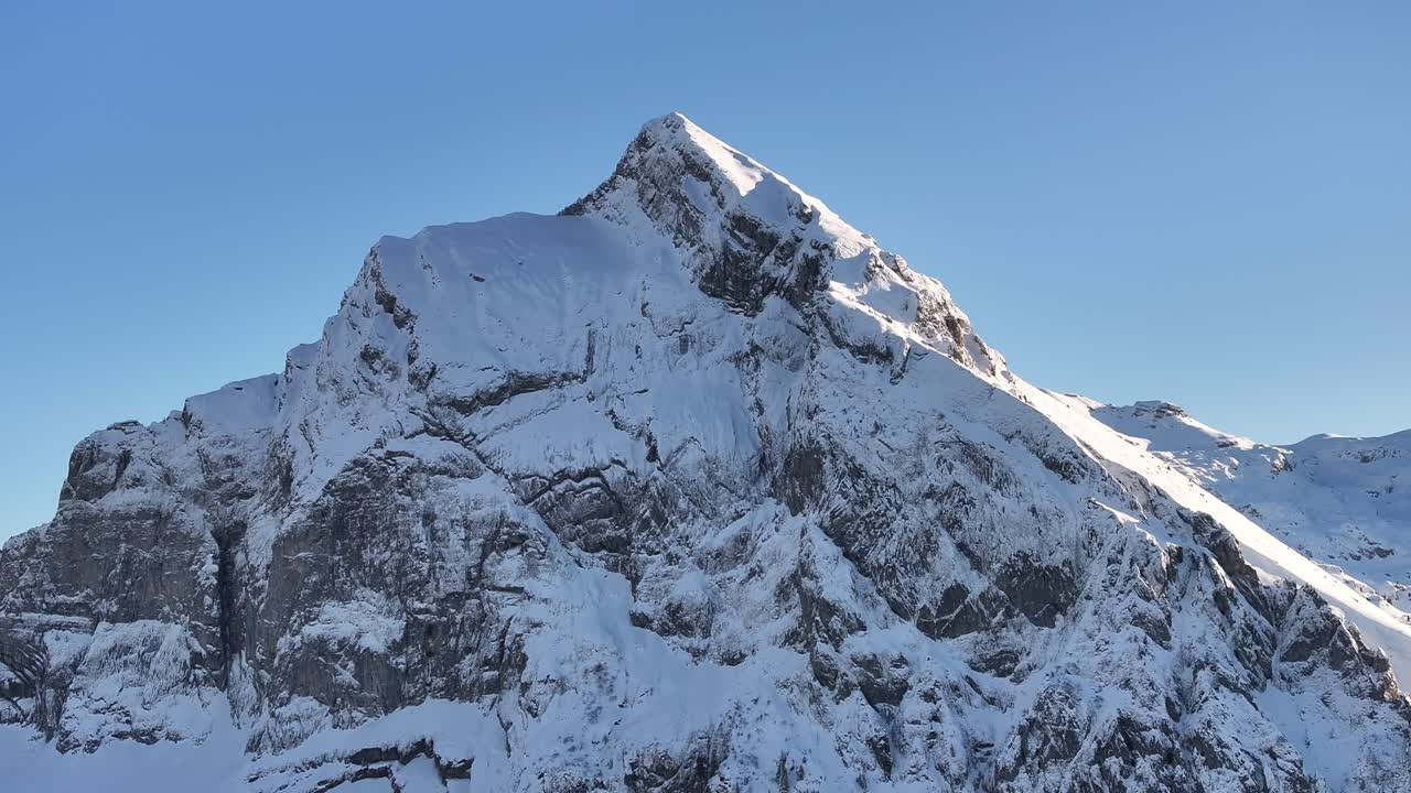 Fronalpstock peak covered in snow under clear blue skies, Kanton Glarus, Switzerland