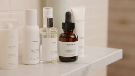 skincare routine products on a bathroom shelf