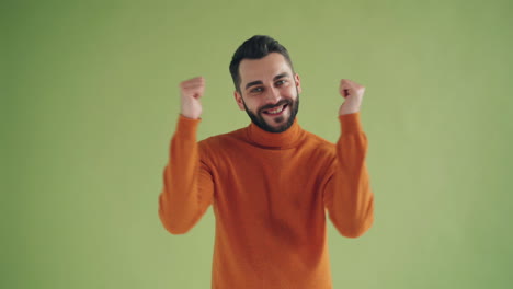 happy man in orange sweater