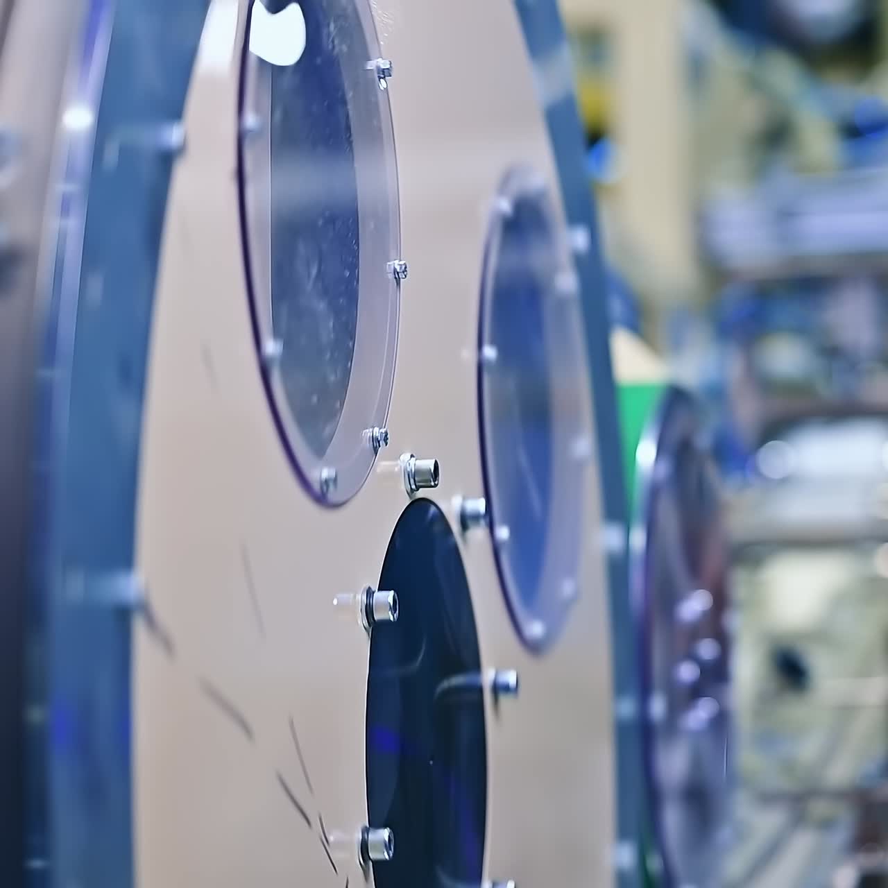 Big round rotating mechanism at the diaper production factory. A number of working devices at the backdrop