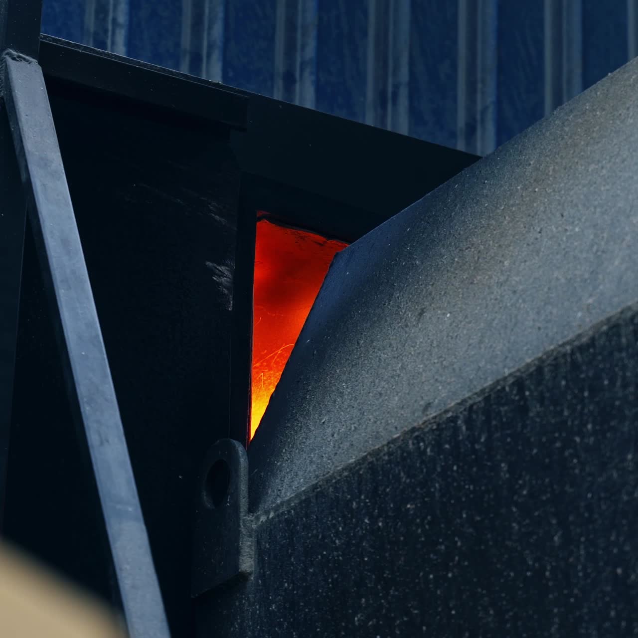 Flashes of fire in the aperture between the elevator parts. Burning fire for the drying of grain in the grain elevator for storage crop