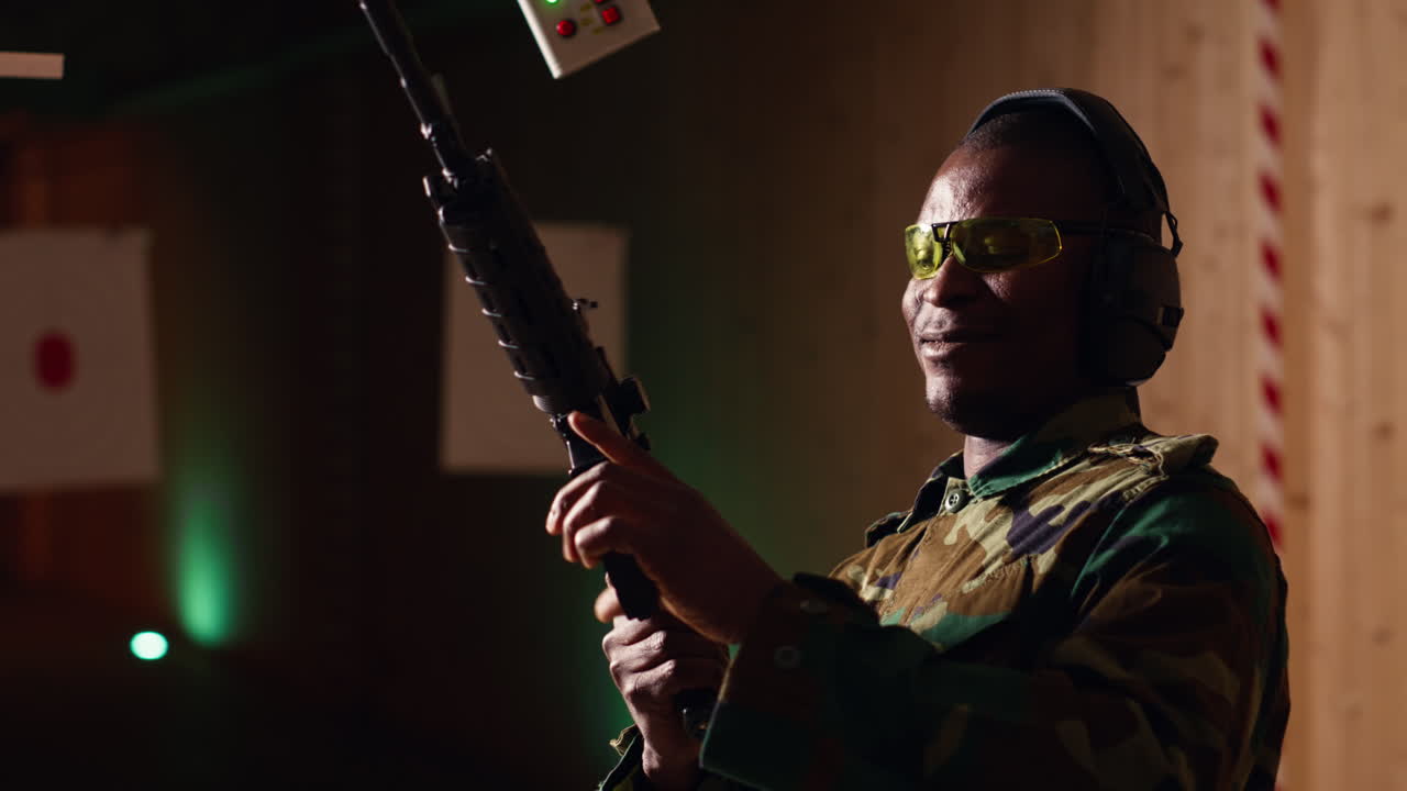Portrait of cheerful soldier doing training in shooting range, reloading rifle